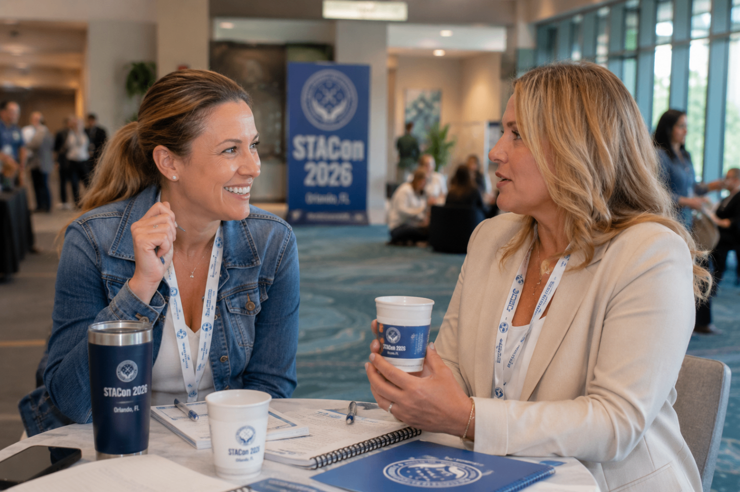Two attendees having coffee and conversation at STACon.