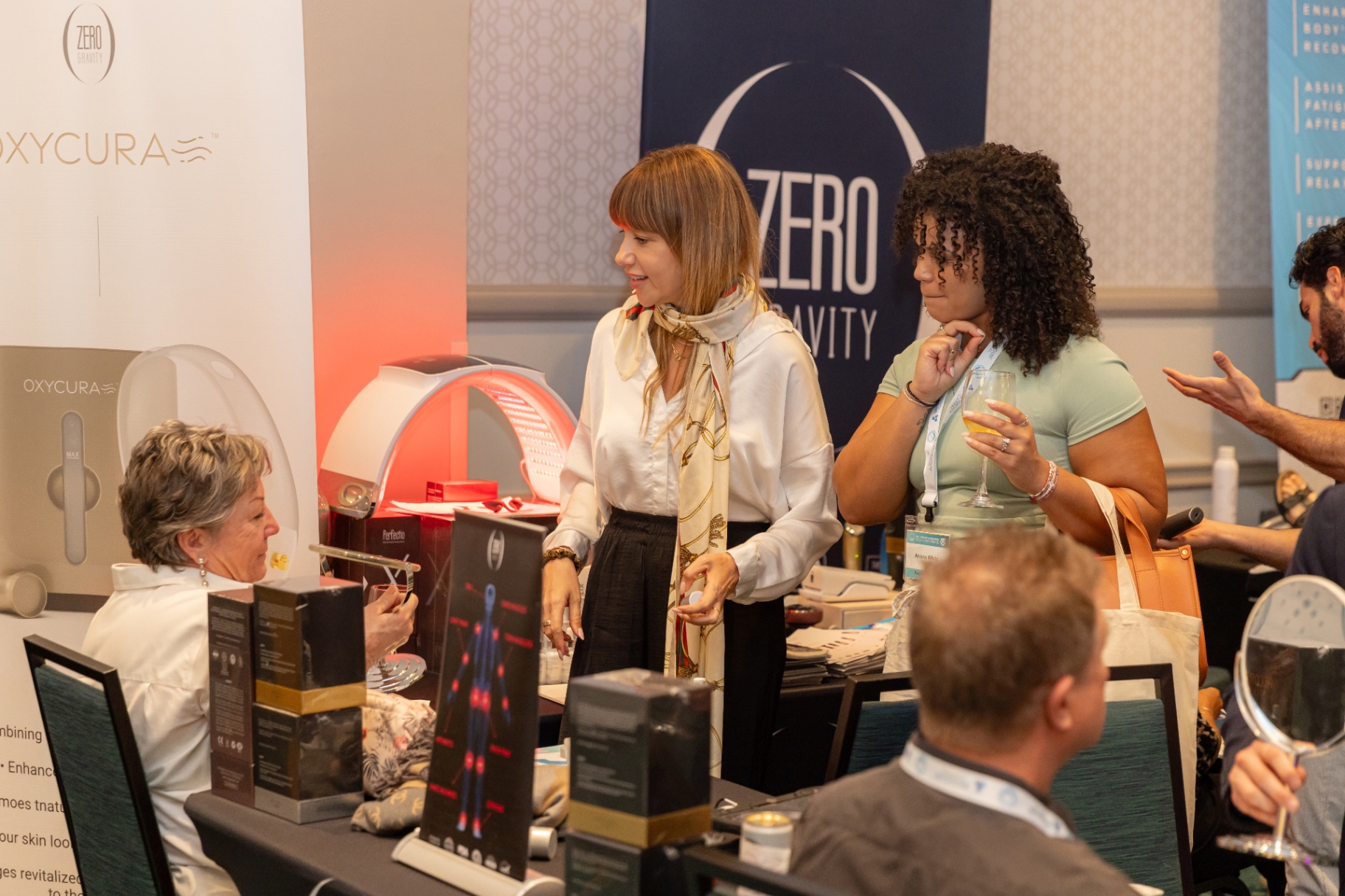 Conversation at the OxyCura and Zero Gravity vendor booth.