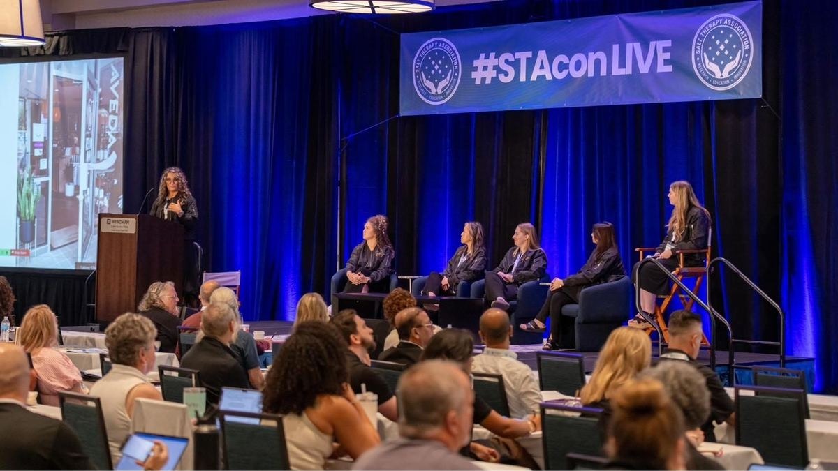 STAcon Live keynote panel on stage with a full audience.