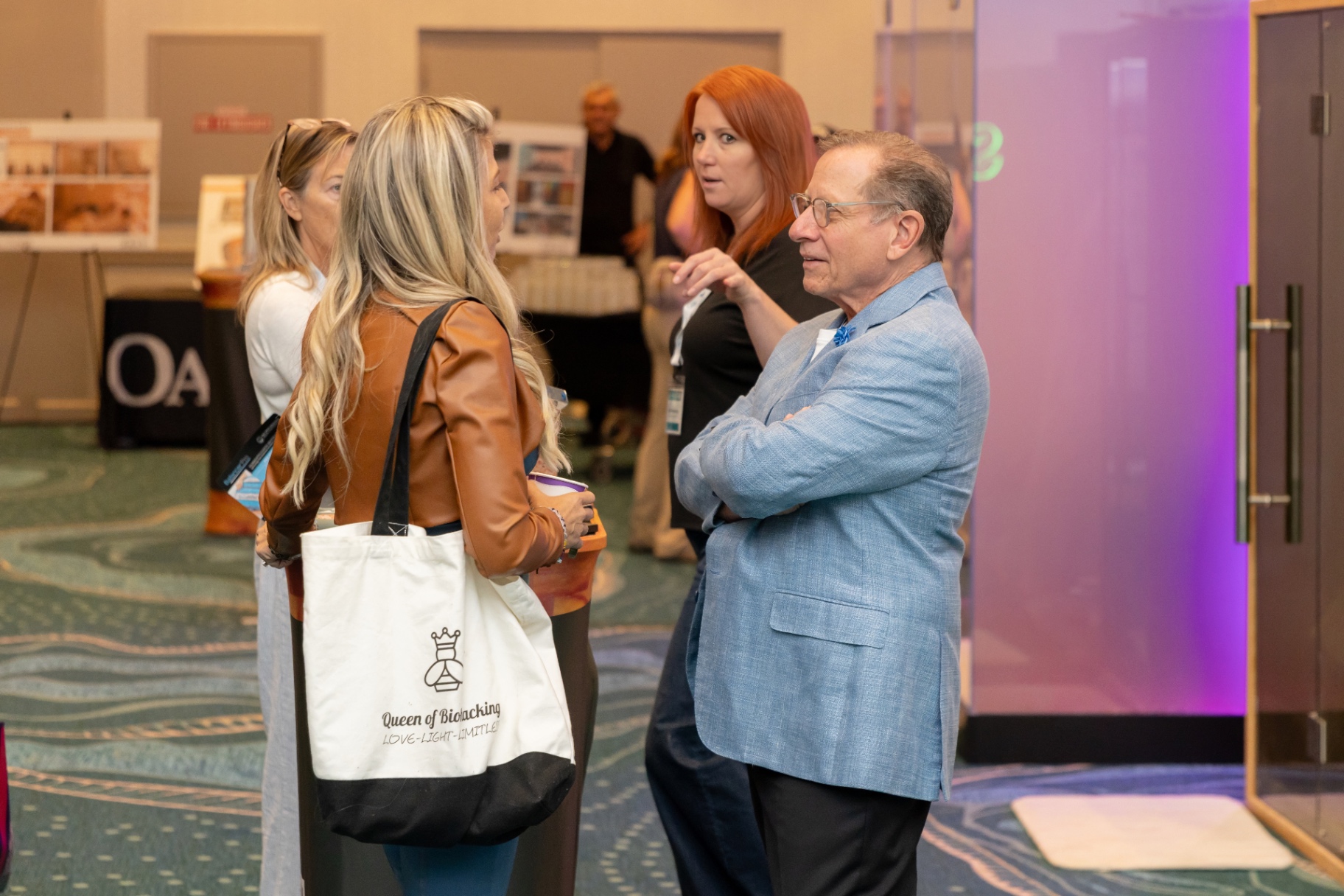 Attendees networking in a STACon hallway.