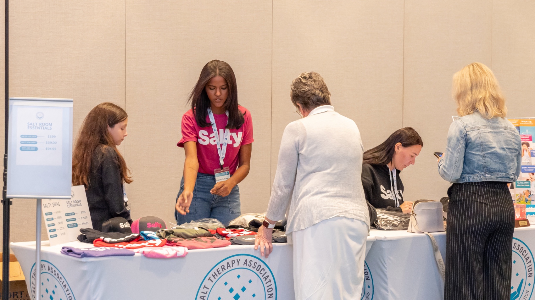 Attendees shopping the Salty merch and Salt Room Essentials table.