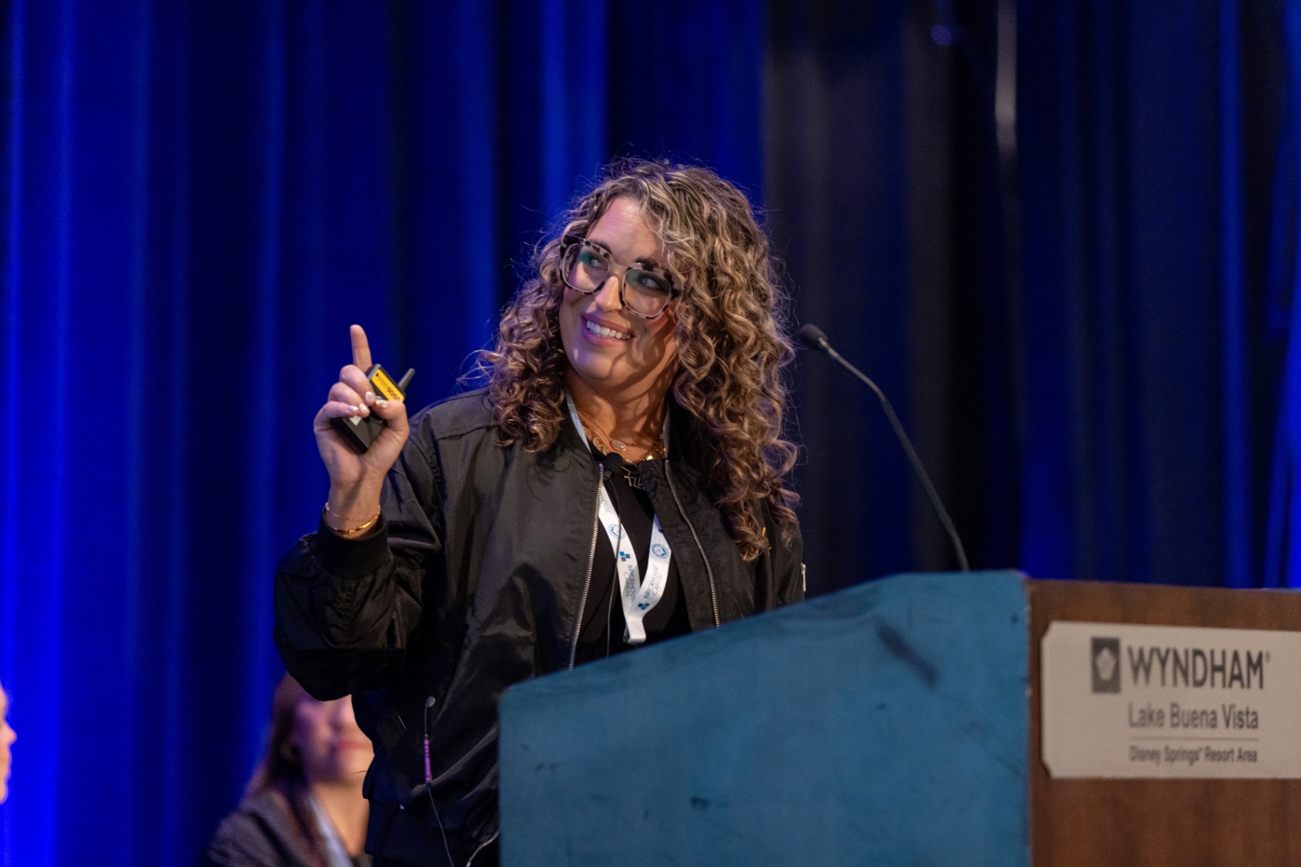 Speaker laughing at the podium during a STACon breakout session.
